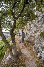 Hikers on the trail to the ruins of Castell Alaro