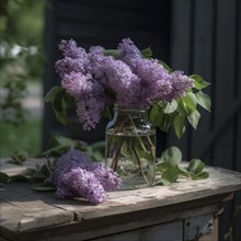 Lilacs in a vase on a wooden table