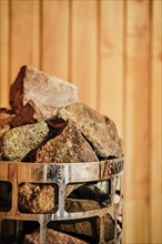 Closeup view of rocks and stones in cage in sauna heater