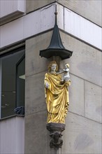 Coloured sculpture of Mary with the Child on a residential house