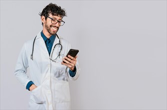 Young doctor with phone isolated