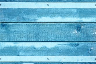 Wooden background with blue colored planks