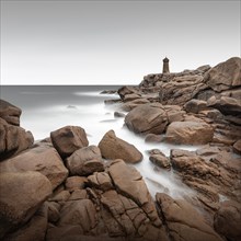 Long exposure of the Phare de Ploumanach lighthouse on the rugged coast of Brittany