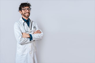 Smiling doctor with crossed arms on isolated background. Latin doctor with crossed arms on isolated background