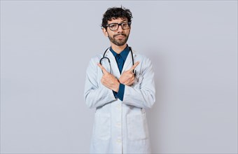Doctor pointing to both sides isolated. Bearded doctor pointing to both sides on isolated background. Doctor pointing at an advertising space with both hands