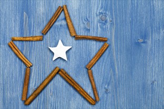 Star of cinnamon sticks on a blue background