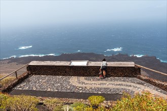 Mother and son visiting the Lomo Negro viewpoint on the southwest coast of El Hierro. Canary Islands