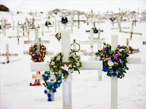 Decorated wooden crosses at Tasiilaq cemetery in winter
