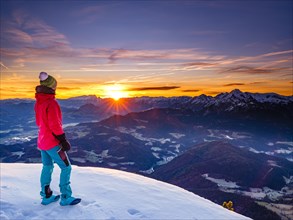 Mountaineer looks into the sunrise on the Berchtesgadener Hochthron