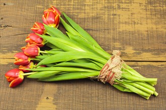 Bouquet of tulips on a wooden background