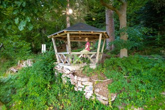 Man sitting in pavilion on the hiking trail Sprollenhaeuser Hut