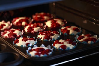 Raspberry muffins in a muffin tin