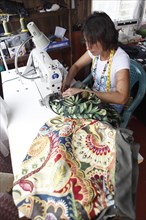 Costa Rican woman sews a bag from recycled fabric