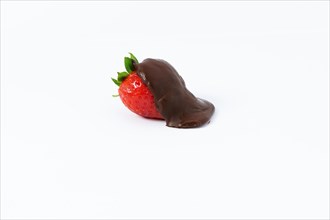 Strawberry covered with melted chocolate isolated on white background