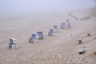 Empty beach chairs on a sandy beach