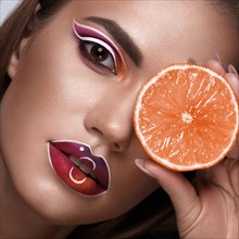 Beautiful caucasian woman with creative makeup and purple lips. Beauty face. Art makeup