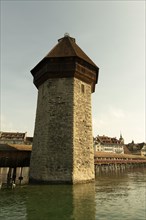 Chapel Bridge Tower in City of Lucerne and Reuss River in Switzerland