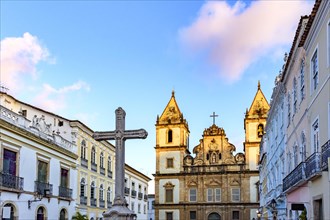 Old houses and churches in colonial and baroque style with a crucifix in the central square of the historic Pelourinho district in Salvador