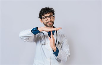 Male doctor gesturing time out. Doctor making time out gesture with palms on isolated background