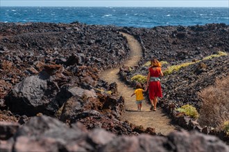 Walking on the volcanic path in the town of Tamaduste on the coast of the island of El Hierro