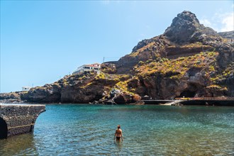 A young woman bathing on vacation in the town of Tamaduste on the island of El Hierro