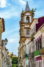 Baroque church tower emerging from among the old houses in the historic neighborhood of Pelourinho in Salvador