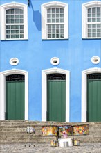 Colorful drums in front of colonial style facade and stairs on the slopes of Pelourinho in Salvador