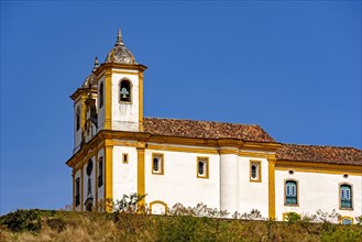 Side view of old and historic church in 18th century colonial architecture on top of the hill in the city of Ouro Preto in Minas Gerais