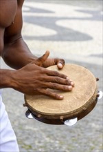 Instrumentalist playing tambourine in the streets of Pelourinho in Salvador in Bahia
