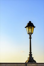 Old colonial style lamppost on the walls of the streets of Salvador