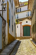 Alley with old houses and chapel in the background in the city of Ouro Preto in the state of Minas Gerais