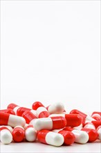 Various medicine pills on white background with free space