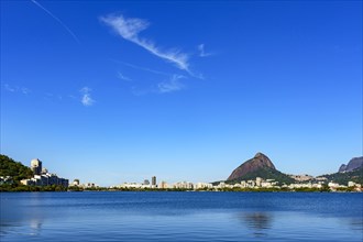 View of the beautiful Rodrigo de Freitas lagoon in Rio de Janeiro. One of the main tourist attractions surrounded by the mountains and buildings of the city
