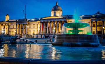 Trafalgar Square and National Gallery at dusk with fountain