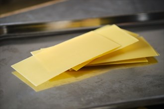 Unprepared raw lasagna pasta on countertop