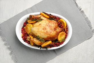 Whole chicken baked with oranges and cranberry