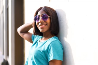 Summer State of Mind: Stylish African American Tourist Woman in Green Tee and Shades