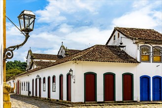 Cobblestone streets and house facades with old colonial-style lanterns in the historic city of Paraty founded in the mid-17th century