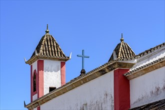 Old and historic baroque church towers seen from behind in the small tourist town of Lavras Novoas