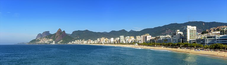Panoramic view of Ipanema beach in Rio de Janeiro with its buildings and mountains around