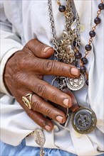 Detail of hands holding religious symbols during a popular festival in Brazil in honor of Saint George