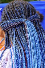 Long blue braids worn by a member of a carnavaval association in Rio de Janeiro for presentation