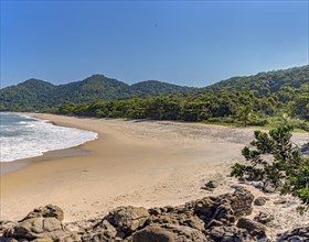 Beach surrounded by untouched forest and mountains in Bertioga on the south coast of Sao Paulo state