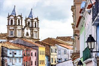 Colorful historic district of Pelourinho with cathedral tower on the background. The historic center of Salvador