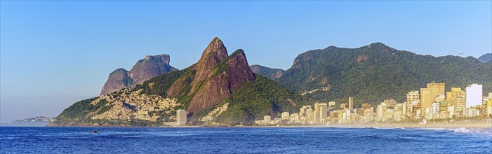 Panoramic image of early morning on Ipanema beach in Rio de Janeiro still empty with its buildings and the surrounding mountains