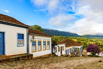 View of the city of Tiradentes with its historic colonial-style houses and mountains in the background during the afternoon in Minas Gerais