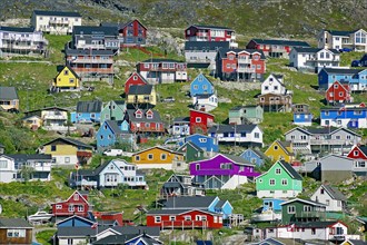 Houses in different colours on a mountainside