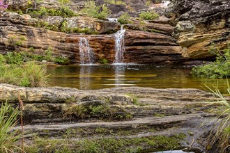 Stream and waterfall among the preserved vegetation of the Biribiri environmental reserve in Diamantina
