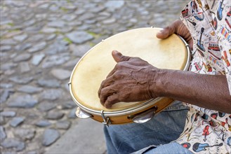 Brazilian samba performance with musician playing tambourine in the streets of Pelourinho
