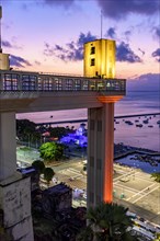Facade of the famous Lacerda elevator illuminated at night of the city of Salvador in Bahia with the sea in background